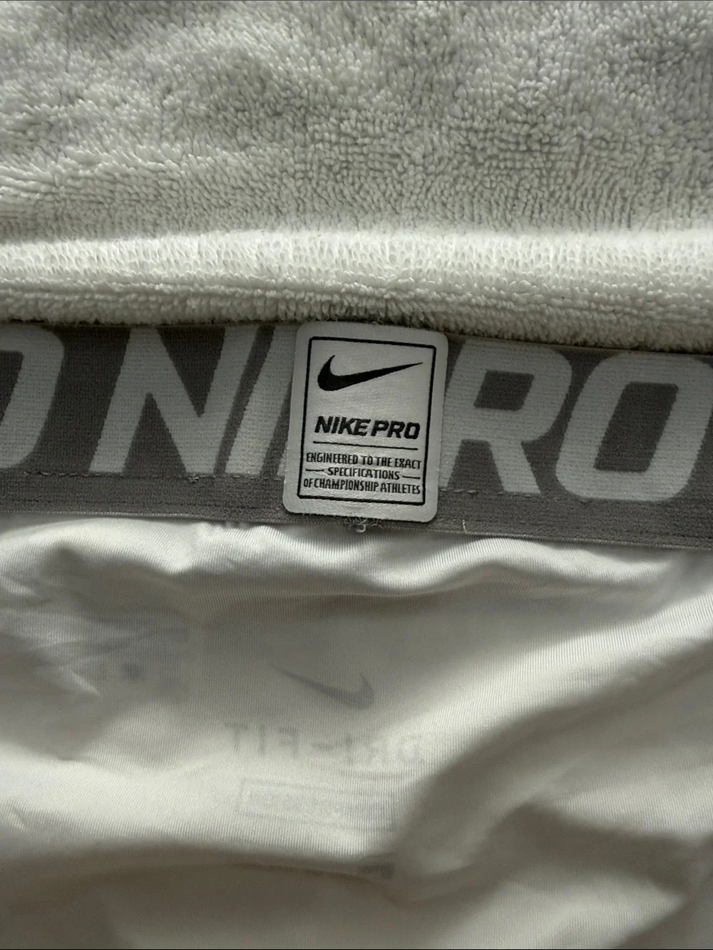 Nike White Pro Compression Shorts with Gray Waistband and Black Swoosh